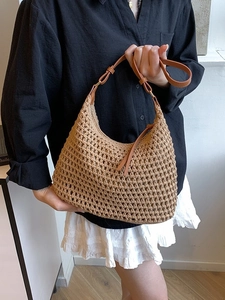 Minimalist woven crochet beach tote with leather straps for a vacation style