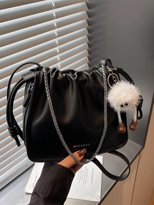 Fashionable black ruched cloud bucket bag with silver chain strap and plush charm