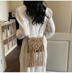Detalle del bolso bandolera tejido bohemio con motivos geométricos beige y flecos largos