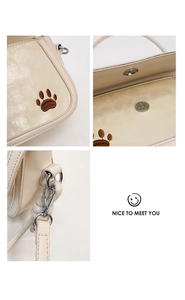 Detailed views of cream crossbody bag featuring animal paw embroidery and silver hardware