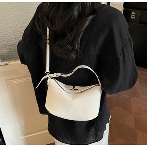 White semi-circle bucket bag with gold metal clasp and adjustable shoulder strap detail