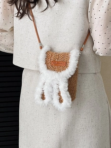 Handmade brown knit crossbody bag with plush rabbit ears and a leather strap