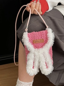 Pink handmade crochet crossbody bag with white plush rabbit ears and leather label