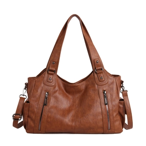 Brown lychee texture leather tote bag with double zippers and adjustable shoulder strap
