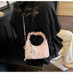 Detail of pink plaid pleated handbag with pearl lace bow and cute bear embroidery