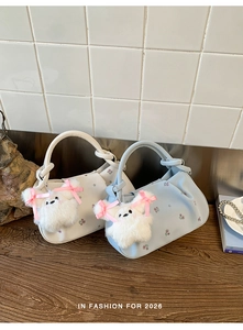 Detail of floral dumpling bags in cream and blue with cute plush animal charms