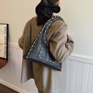 Vintage black faux leather hobo bag with silver rivets and minimalist crescent shape