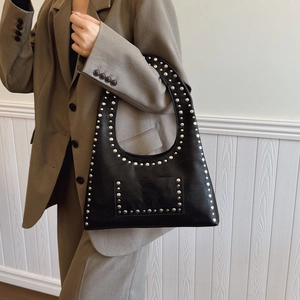 Vintage black studded hobo shoulder bag in premium oil wax leather shown on model