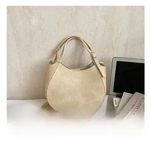 Detail view of beige saddle bag with adjustable strap and Fashion & Bags text
