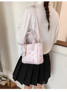 Pink cartoon printed tote bag shown on a model with a cute white bunny plush pendant