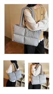 Close-up of a grey quilted puffer tote bag with spacious interior and soft fabric