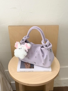 Lavender floral embroidered dumpling bag with knotted handle and plush rabbit charm