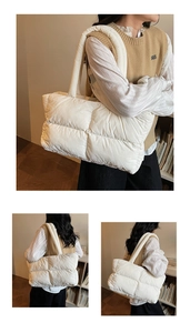 Detailed view of cream quilted puffer shoulder bag with soft textured square stitching