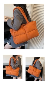 Detail of vibrant orange quilted puffer tote bag showing padded texture and strap