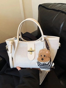 Elegant white canvas tote bag with leather trim, metal lock and cute dog pendant accessory