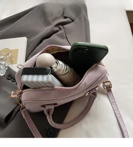 Interior view showing capacity of light purple suede bag with phone and umbrella