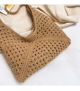 Detailed close-up of natural woven fiber texture on the khaki summer beach tote bag