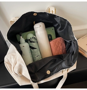 Detail view of large canvas tote bag interior with magnetic closure and inner lining