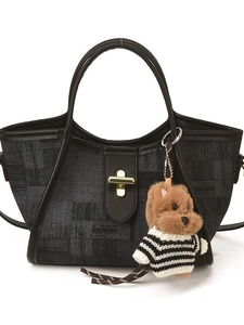 Deep grey textured bucket bag with leather trim and cute puppy charm on white background