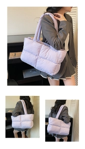 Detail view of large quilted light purple puffy shoulder bag with padded handles