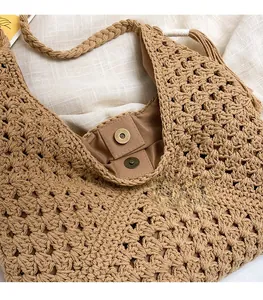 Close-up of premium hardware magnetic clasp and inner lining on woven tote bag
