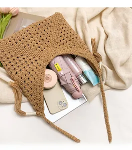 Detail showing high-capacity khaki woven tote bag with daily travel essentials and items
