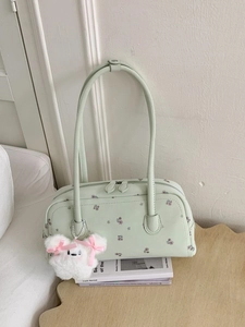 Mint green floral underarm bag with teddy bear pendant for women on stylish desk