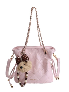 Pink quilted leather bucket bag with gold chain strap and plush bear charm