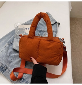 Detail of caramel puffer tote bag with quilted nylon texture and shoulder strap