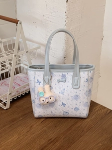 Cartoon printed mini tote bag with light blue straps and cute plush rabbit charm