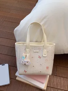 Cartoon animal print bucket bag in cream faux leather with a cute plush bunny charm