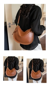 Detail of vintage brown crescent tote bag with gold rivet studs and adjustable strap
