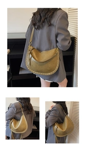Detail of olive green crescent tote with gold rivets and adjustable shoulder strap