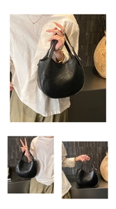 Detail of black crescent hobo bag with retro lychee texture and metallic buckles