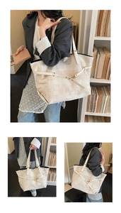 Detail of beige canvas tote bag with jacquard texture and decorative leather buckle