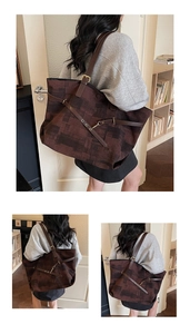 Detailed macro shot of large brown tote bag with geometric canvas and leather strap