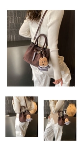 Details einer dunkelbraunen Mini-Eimertasche aus Wildleder mit Teddy-Anhänger