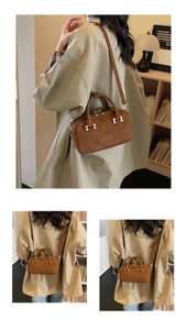 Close-up of brown corduroy handbag with ROSY MODERNA embossed logo and silver hardware