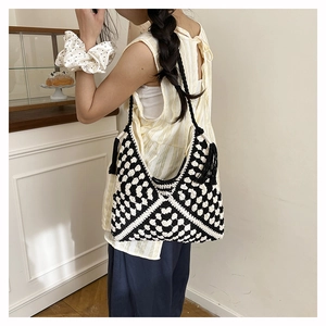 Detail of checkered crochet tote bag with fringe tassels and woven shoulder strap