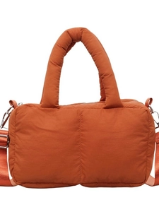 Quilted rust orange puffer tote bag with padded handles and adjustable shoulder strap