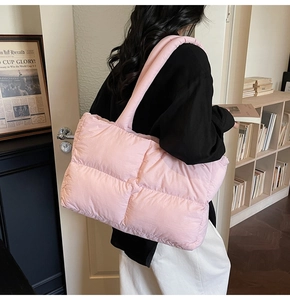 Detail of pink quilted puffer tote bag with soft padding and shoulder strap for women