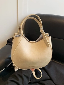 Minimalist beige moon-shaped PU leather handbag with adjustable silver buckle handles