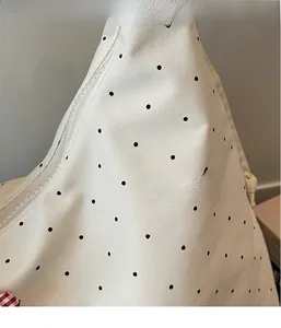 Detail of white floral pattern fabric with zipper on a lightweight tote bag