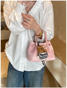 Detail der rosa gemusterten Stofftasche mit Teddybär-Anhänger für Damen