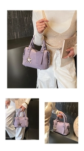 Close-up of purple lychee pattern leather handbag with silver star charm details