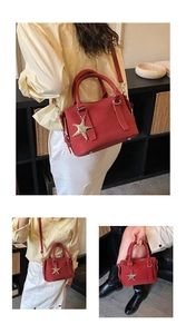 Detail view of red bowling bag with starfish gold charm and adjustable shoulder strap