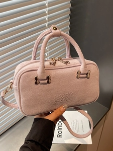 Lavender faux suede bowling handbag with top handles and gold-tone metal hardware