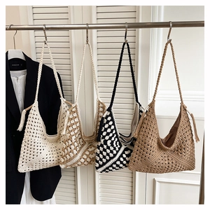 Detail of woven tote bags showing intricate textures and braided shoulder straps