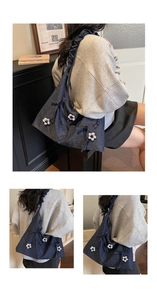 Detail of navy blue tote bag featuring white polka dots and 3D floral accents with scrunchie strap