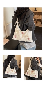 Detailed shot of white polka dot shoulder bag with red floral accents and bow ribbon